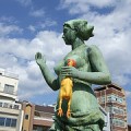 Humorous picture of statue with rubber chicken